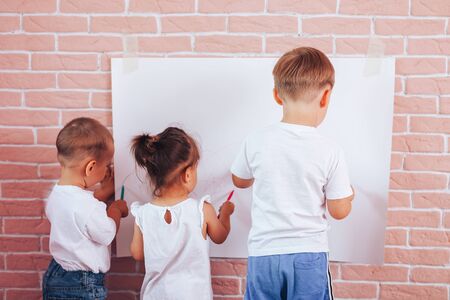 Little children draw on paper, home schooling, preschool education.の写真素材