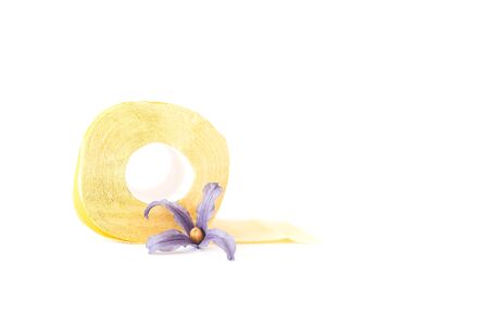 Yellow toilet paper roll with flower on white background.の写真素材