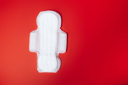 sanitary napkin on red background, health care, monthly protection, reliable friend.の写真素材