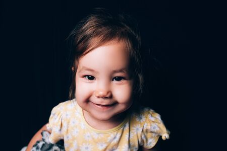 Smiling mixed nation little toddler girl looking at camera and smilingの写真素材