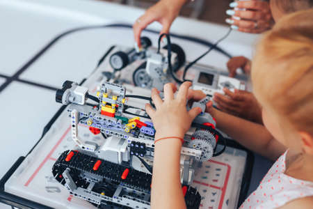 Two schoolgirls study in a robotics class, assemble a robot constructor.の写真素材