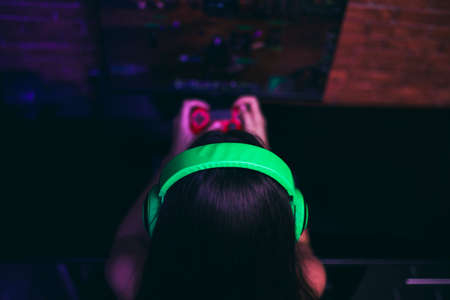 Computer games, playing place, young gamer playing video games with headphones.の写真素材