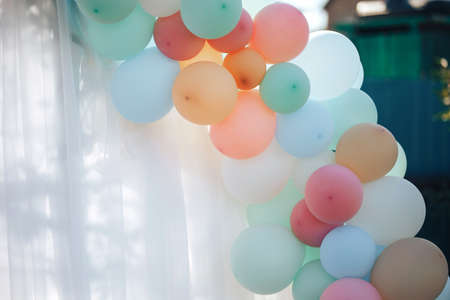 Multicolored balloons are filled with helium and connected to each otherの写真素材