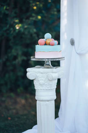 Two-tier cake is two-tone, the bottom of the cake is pink and the top is blue, the cake has different ballsの写真素材