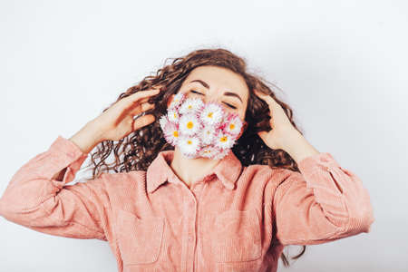 Young girl in a medical mask made of flowers, wants to breathe freely, polluted air