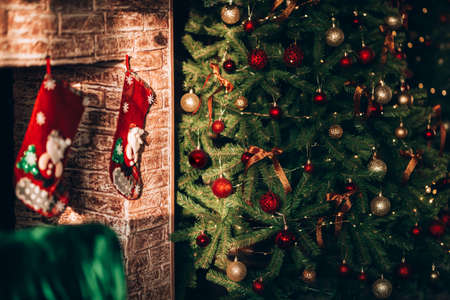 A beautiful and decorated Christmas tree and a large fireplace. Christmas mood. Great photo for store advertising.の写真素材
