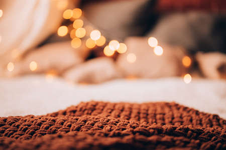 Brown plaid with a blurred background of a Christmas garland. Great photo for advertising. Place for textの写真素材