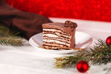 Chocolate cake on a white plate. A piece of chocolate cake on a white plate. Traditional sweets for...