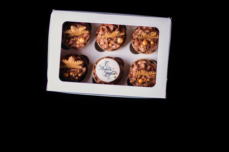 Chocolate cupcakes with star-shaped cookies in a white box. Christmas mood. Sweets for any occasion.の写真素材