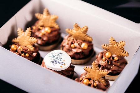 Chocolate cupcakes with star-shaped cookies in a white box. Christmas mood. Sweets for any occasion.の写真素材
