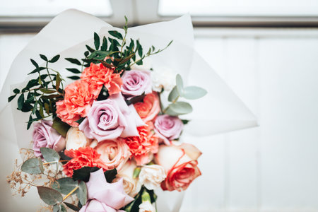 A large beautiful bouquet of mix flowers on a light background. A gift for any occasion or wedding. Flower shop advertising banner.の写真素材