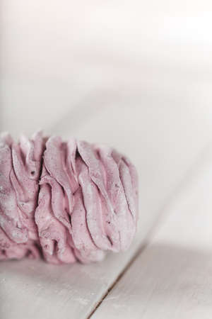 Appetizing pink marshmallow on a wooden table. Tea drinking concept. Confectionery decoration. Place for text.の写真素材