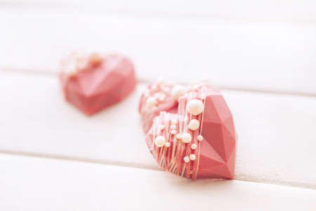Pink heart-shaped cake. Gift for Valentine's Day and Women's Day.