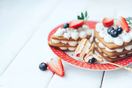 Delicious sweet flaky snack with berries on top on a plate. A sweet snack for any holiday. Holiday...