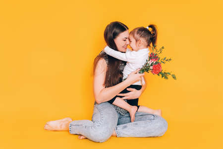 Daughter gives gift to her mother. Congratulations to the parents on the holiday.の写真素材