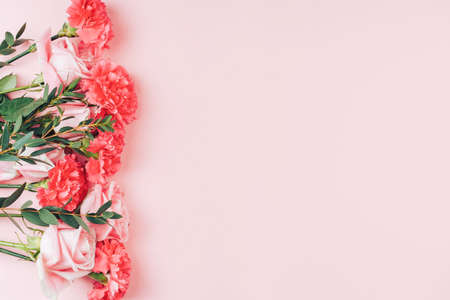 Beautiful bouquet of roses in front of pink background. Free space for text.の写真素材