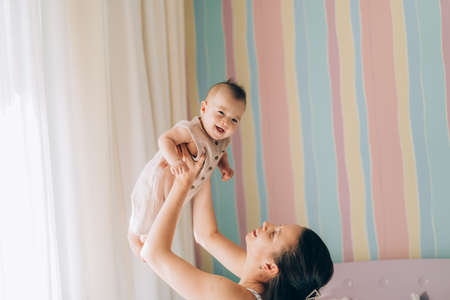 Young mother hugs her mixed race child. Child adoption and In Vitro Fertilization IVF.