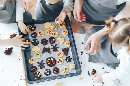 Kids put cookies on baking sheet, hand made cookies