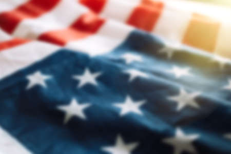 Blurred american flag background with sunlight. Fourth july concept.の写真素材