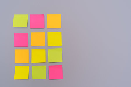 Table of colorful stickers on lilac wall.