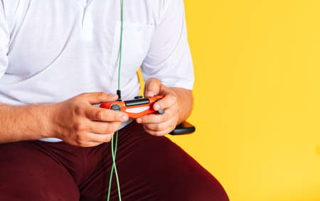 Guy holding game controller playing video games.の写真素材