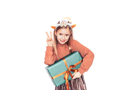 Girl with horns on her head holding gift in front of white background.