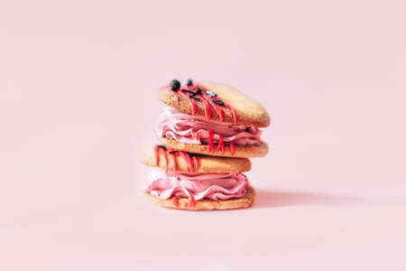 Heart-shaped cakes are positioned in the middle of pink background. Homemade cakes for holiday,...