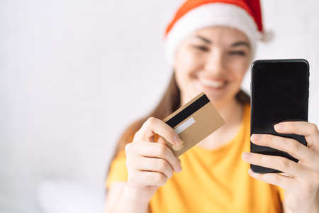 Girl pays for christmas gifts with credit card online.