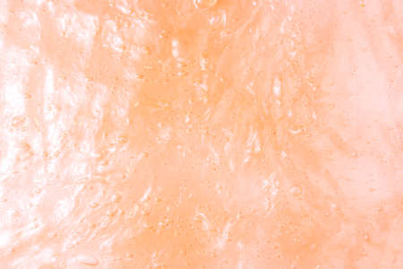 Liquid orange slime background with bubbles and highlights.の写真素材