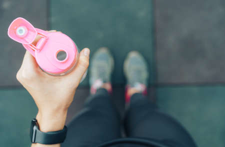 Girl in sportswear holding bottle of water.の写真素材