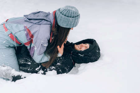 Guy and girl fooling around in the snowの写真素材