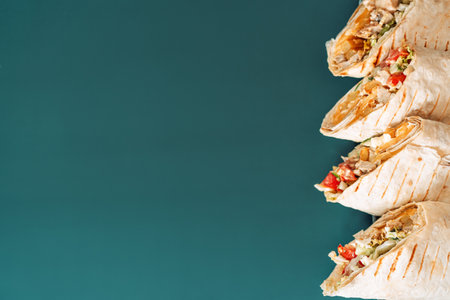 Four shawarma cutaway on cyan background.の写真素材