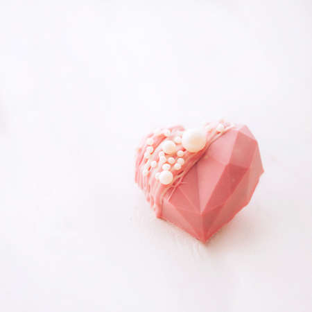 Pink heart-shaped cake. Gift for Valentine's Day and Women's Day.