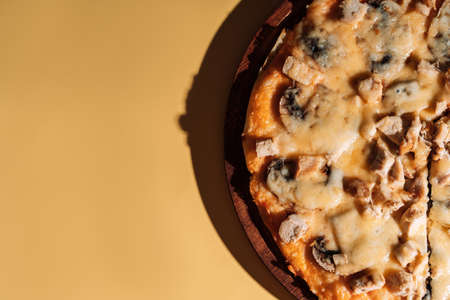 Pizza with mushrooms on wooden trayの写真素材