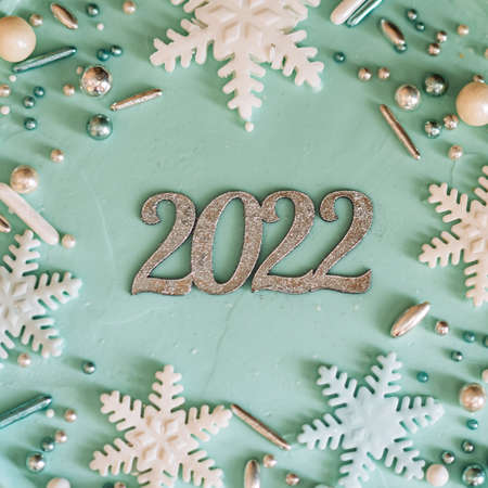 2022 lettering on turquoise new year cake with snowflakes.の写真素材