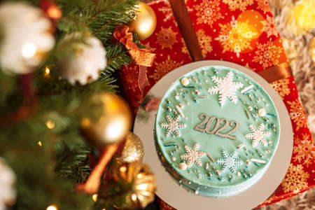 Turquoise Christmas cake with 2022 lettering on gift boxes.の写真素材