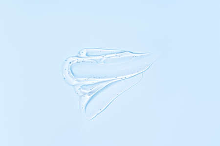 Transparent serum smear on blue background.の写真素材