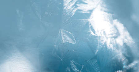 Texture of ice covered glass against blue backgroundの写真素材