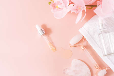 Massage tools on pink background with orchid.の写真素材