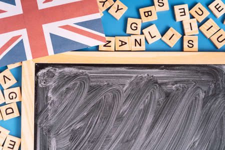 Chalkboard with white streaks next to the letters and the British flagの写真素材