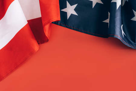 Folded USA flag on a red backgroundの写真素材