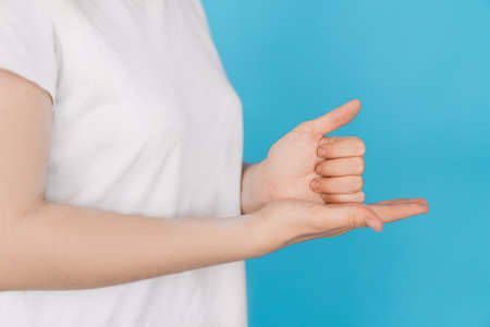 Girl showing help in sign languageの写真素材