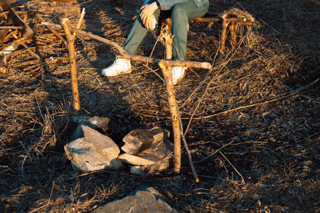 Girl is resting outdoors in front of the fire