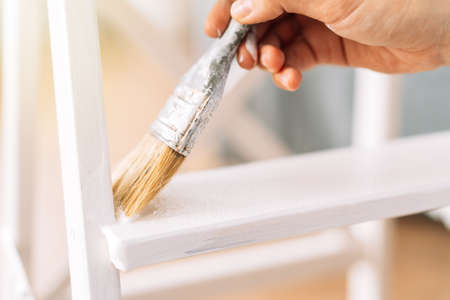Painting wooden products white colour with brushの写真素材