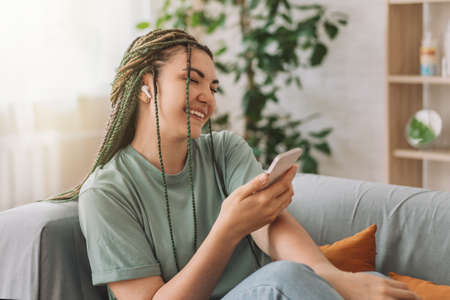Girl listening to music sitting on the couch