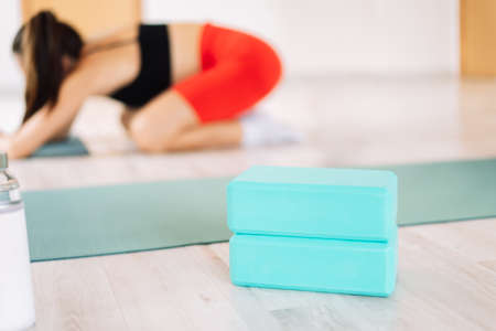 Close-up yoga supplies in front of a girlの写真素材