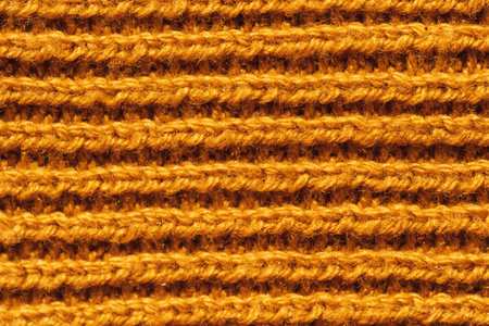 Background of yellow knitted woolen thread close-upの写真素材