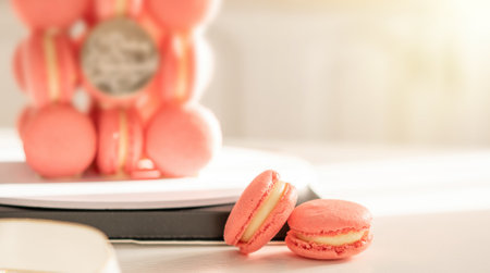 Pink macaron cake on round stand in the sunの写真素材