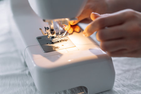Lady threading a sewing machine needle