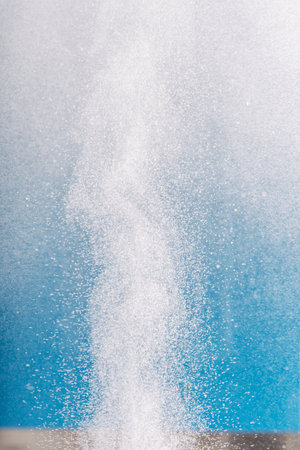 Column of hydrogen bubbles in water against blue background